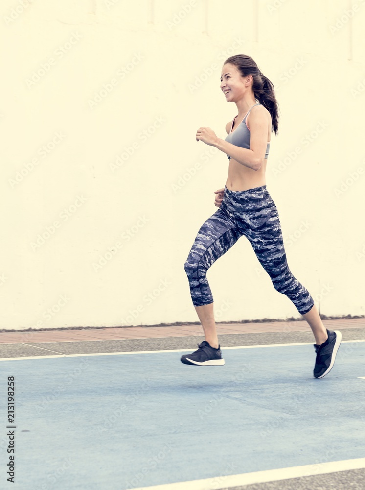 White woman running on track