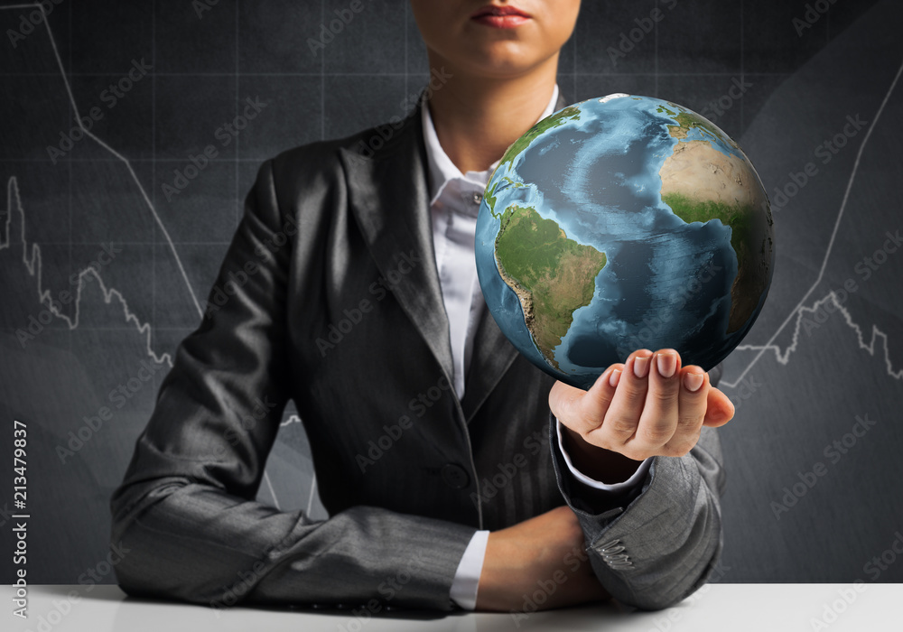 Businessman presenting Earth globe.