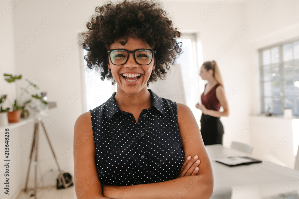 Woman laughing during presentation in office