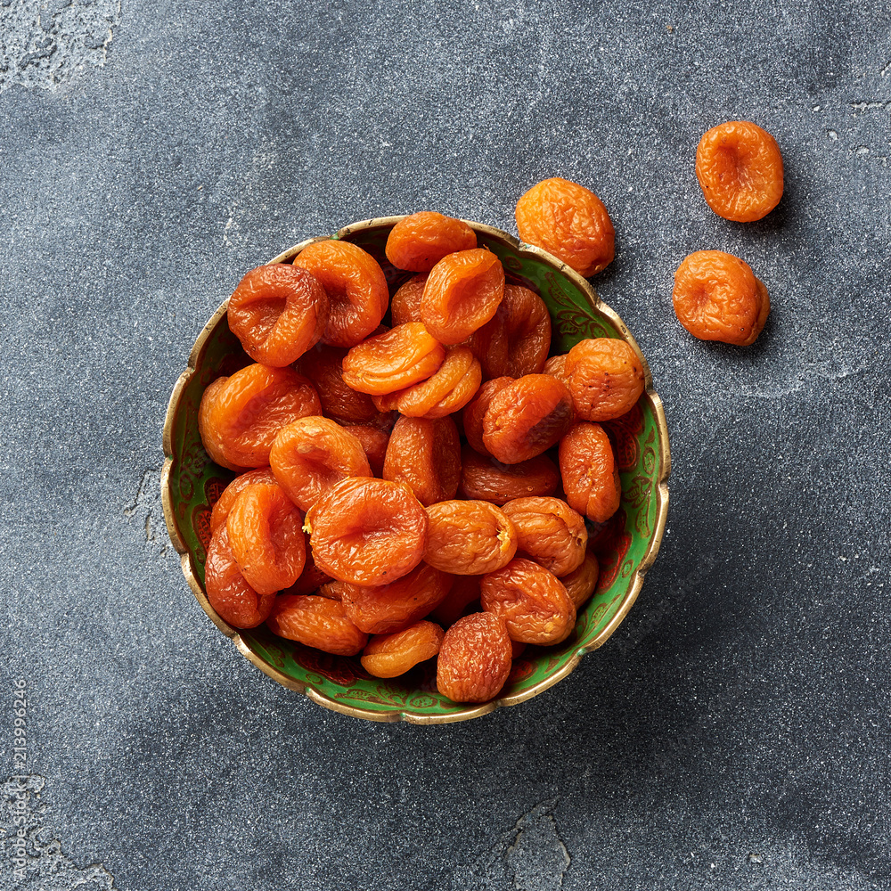 Dried apricots on gray background. Top view.