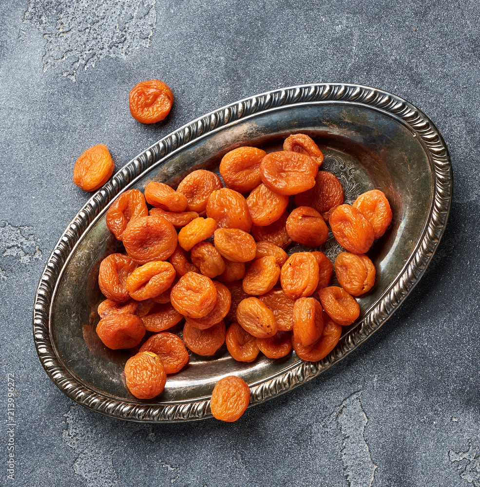 Dried apricots on gray background. Top view.