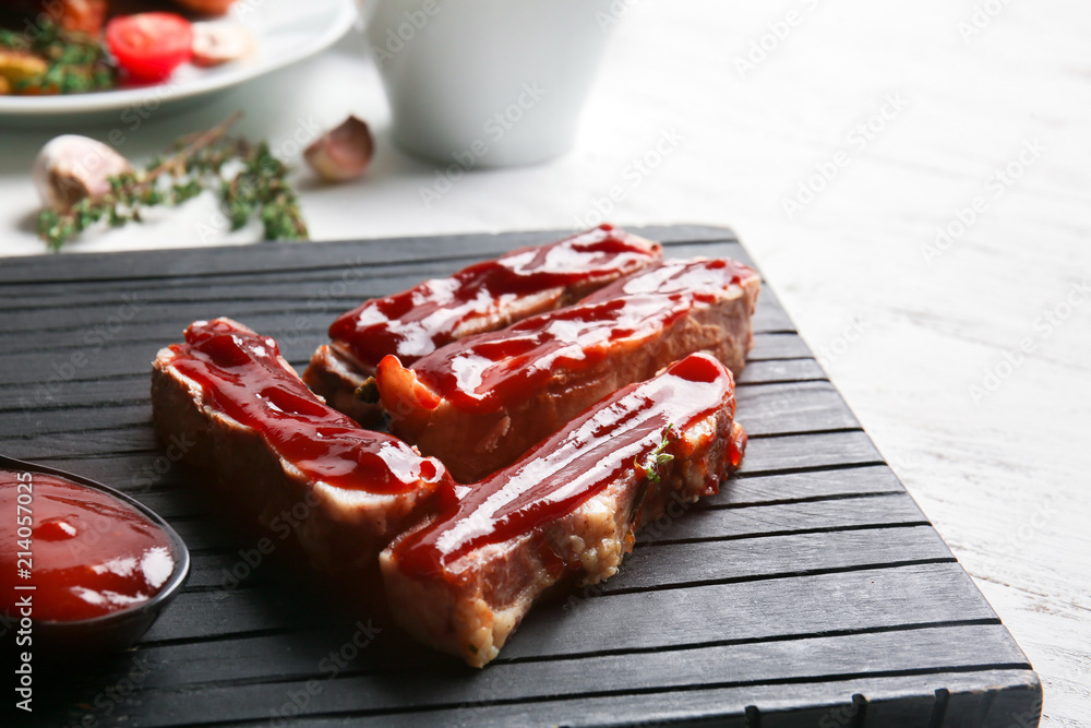 Grilled meat with delicious barbecue sauce on wooden board, closeup