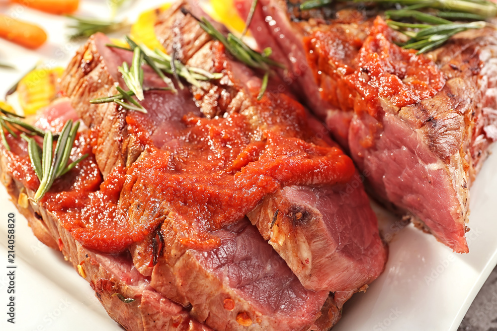 Tasty meat with sauce and rosemary on plate, closeup