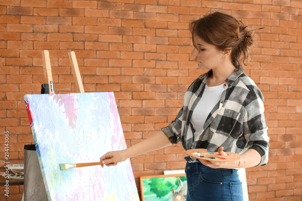 Female artist painting in workshop