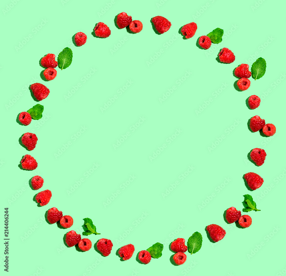 Raspberries and mints on a solid color background