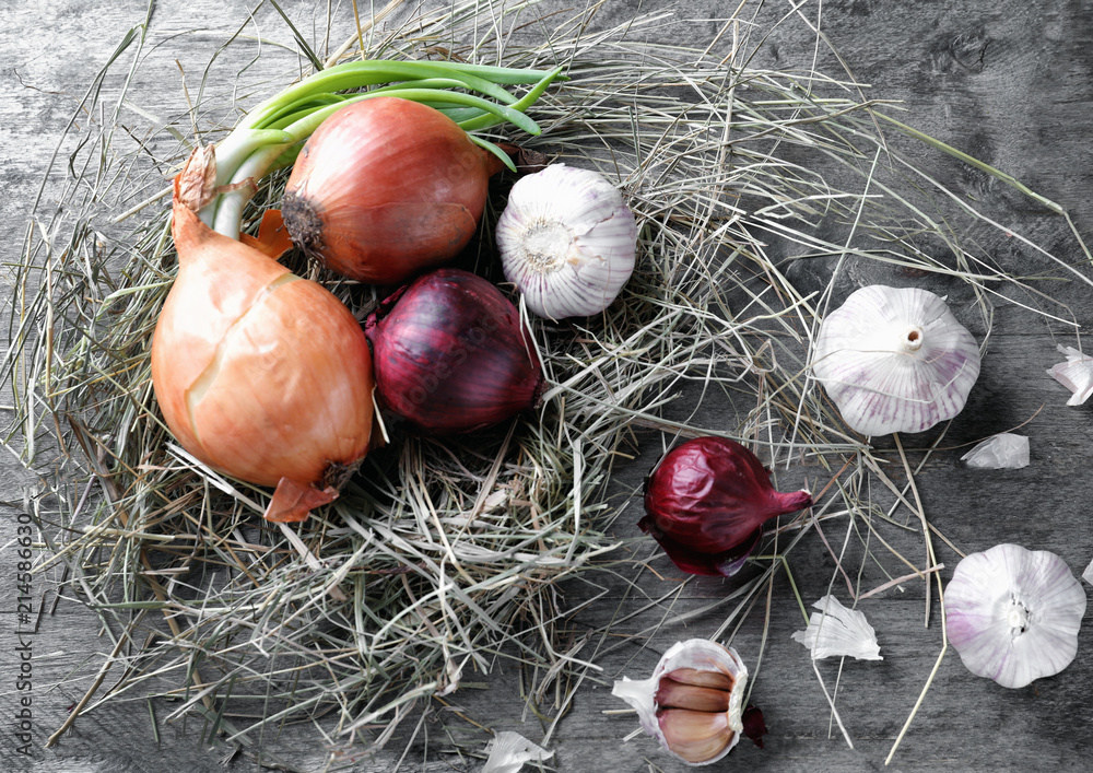 Fresh garlic with onion on wooden background