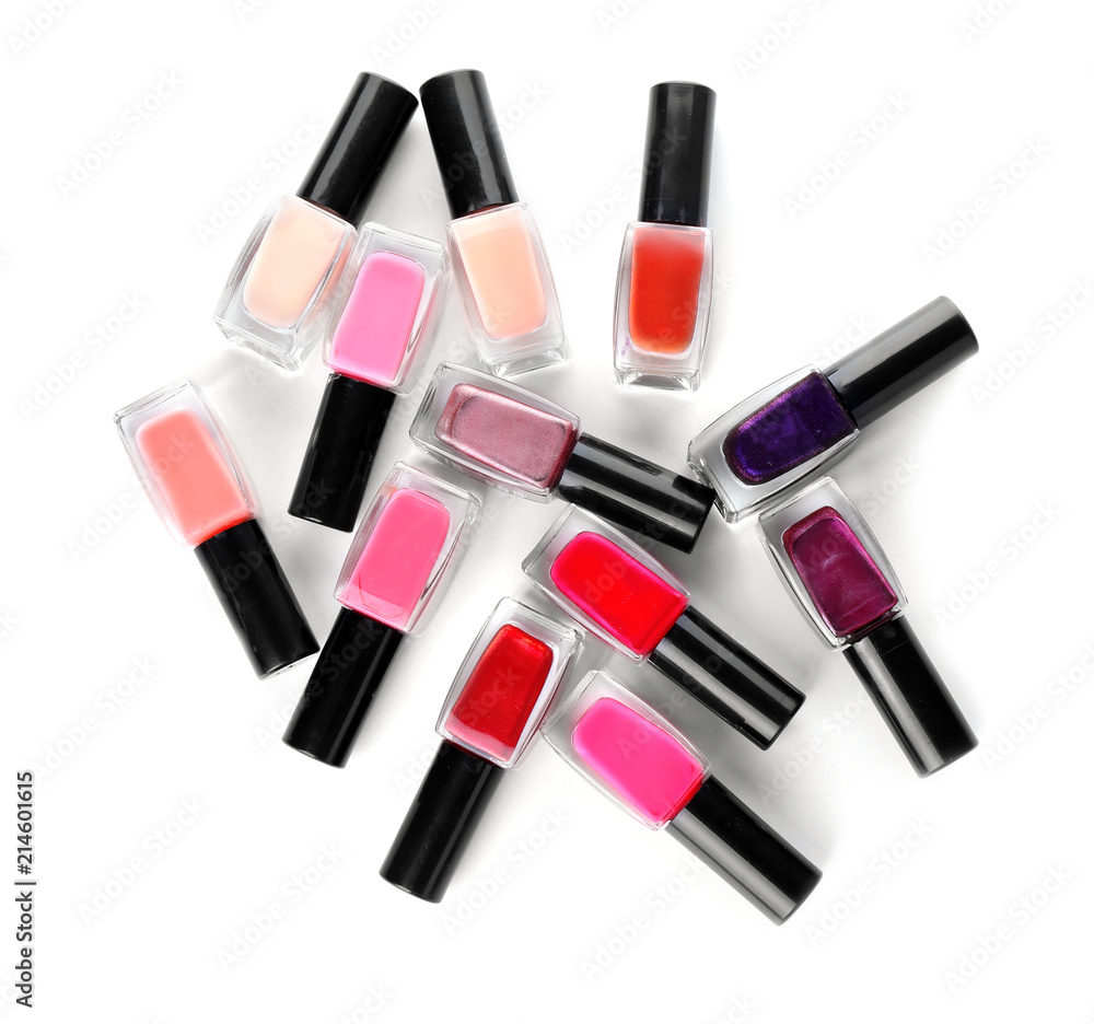 Bottles of colorful nail polishes on white background