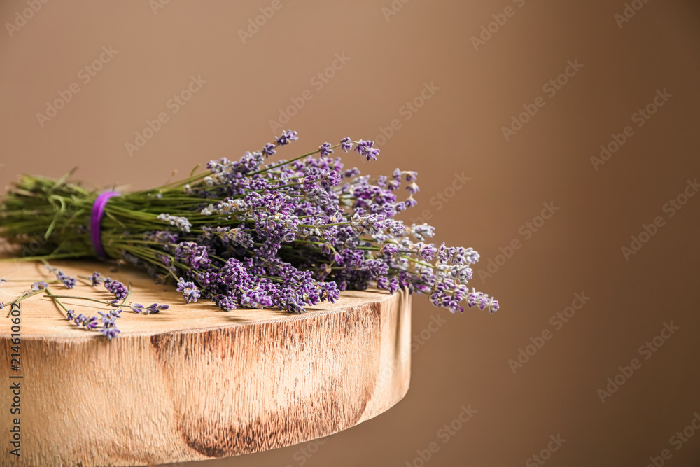 Table with beautiful lavender on color background