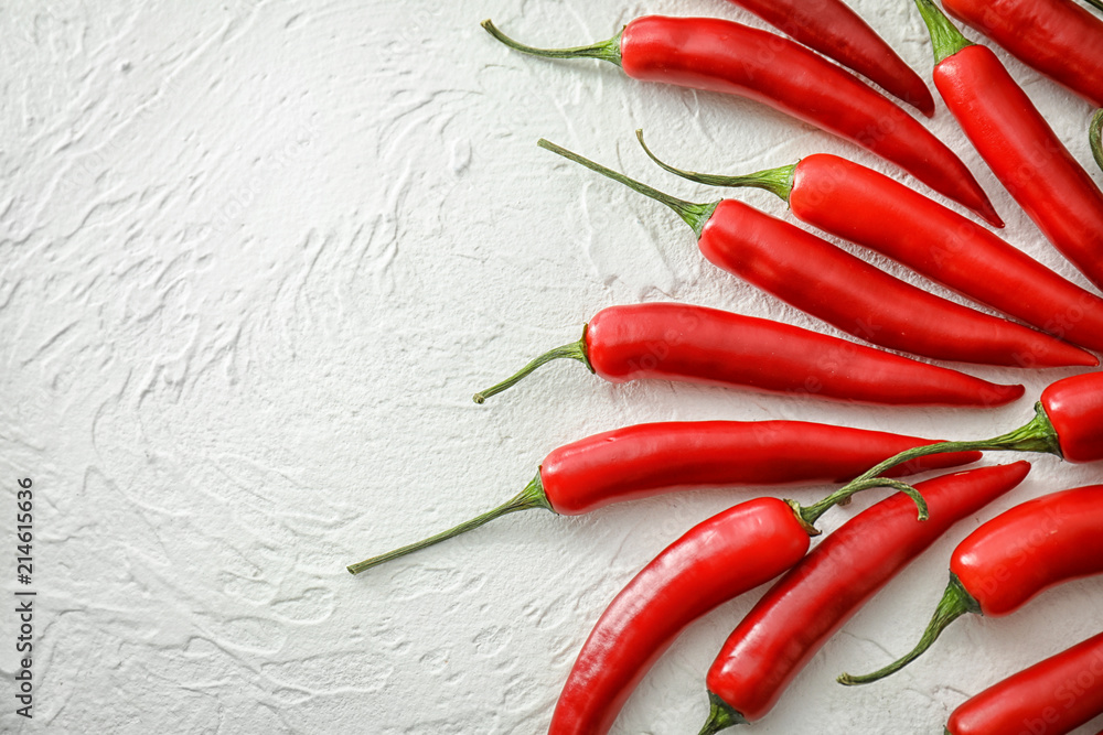 Fresh chili peppers on light background