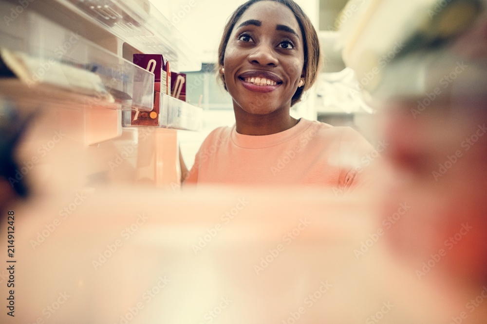 African descent woman open the fridge