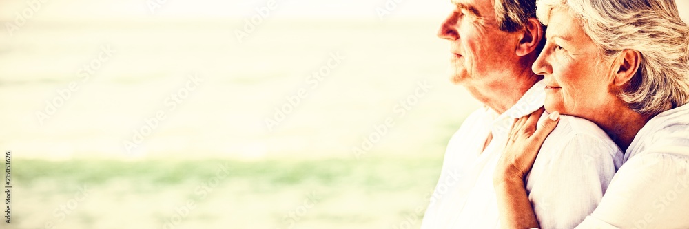 Woman hugging her husband at the beach