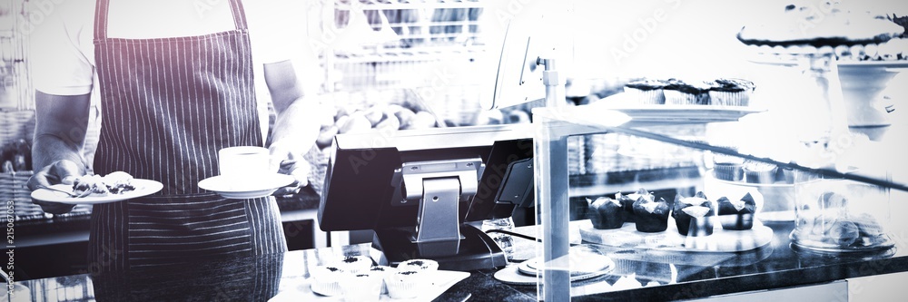 Smiling worker prepares breakfast