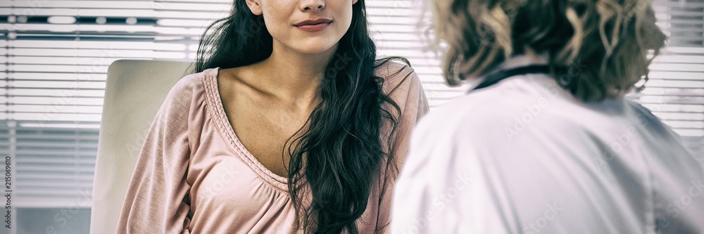 Female patient listening to doctor with concentration in medical