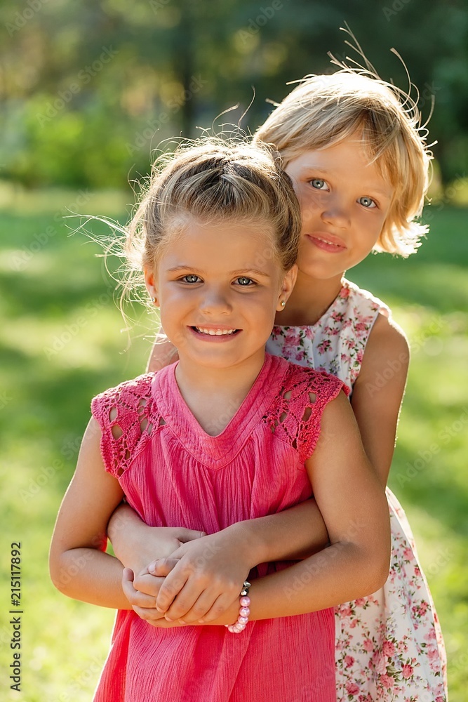 Portrait of Two Little Girlfriends / Sisters Hugging