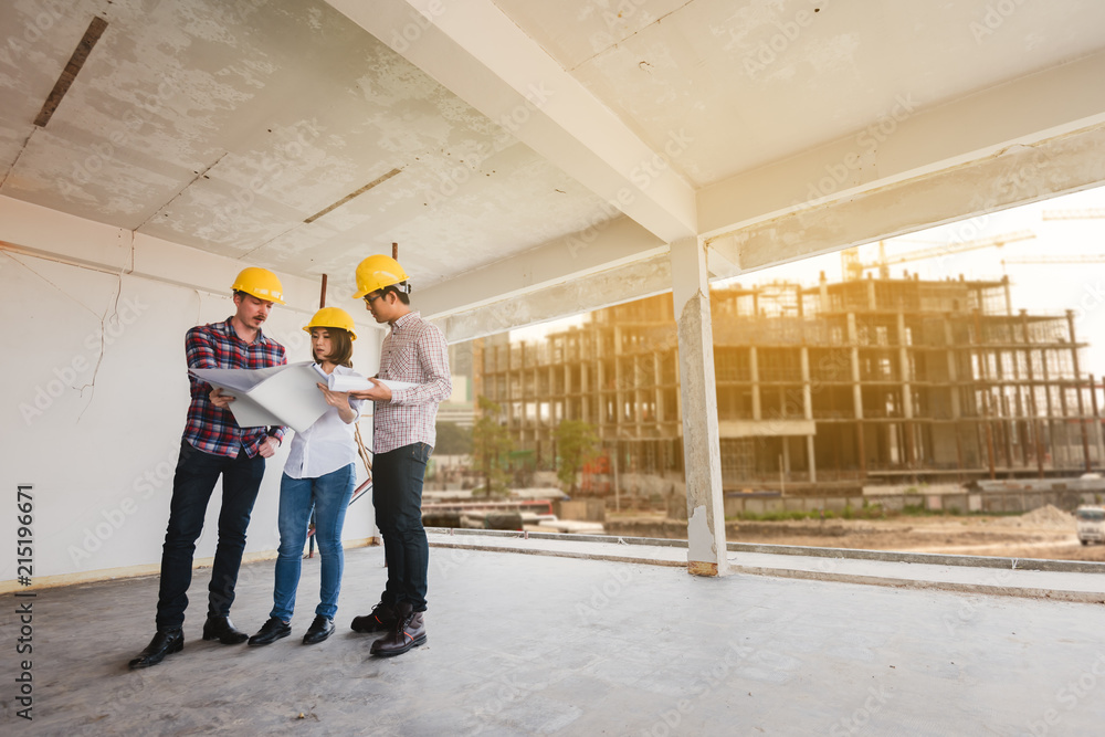 three construction engineers working together in construction site planning for the renovation