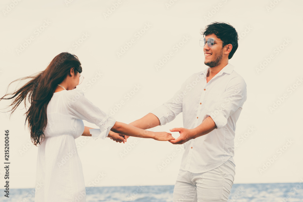 Couple going honeymoon on tropical beach in summer