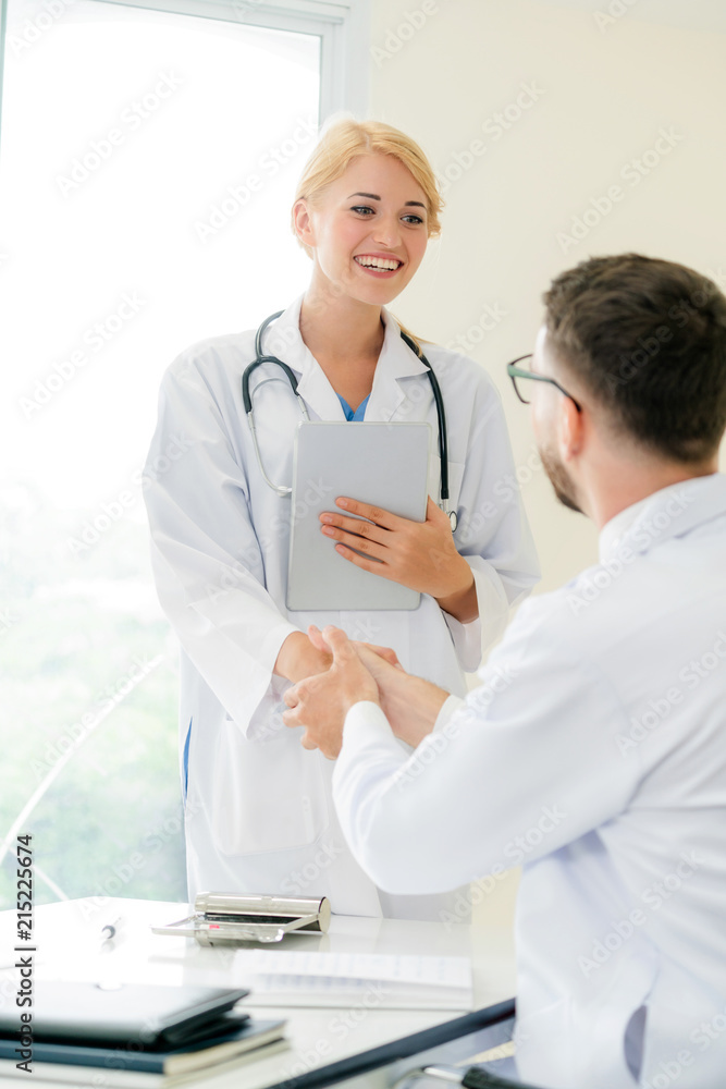 Doctor at hospital shakes hand with another doctor