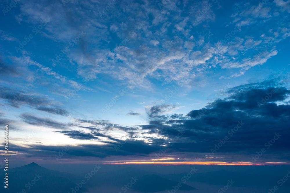 Morning dark sky with the blue cloud and rim light of the sunrise on the top of mountaing view of no