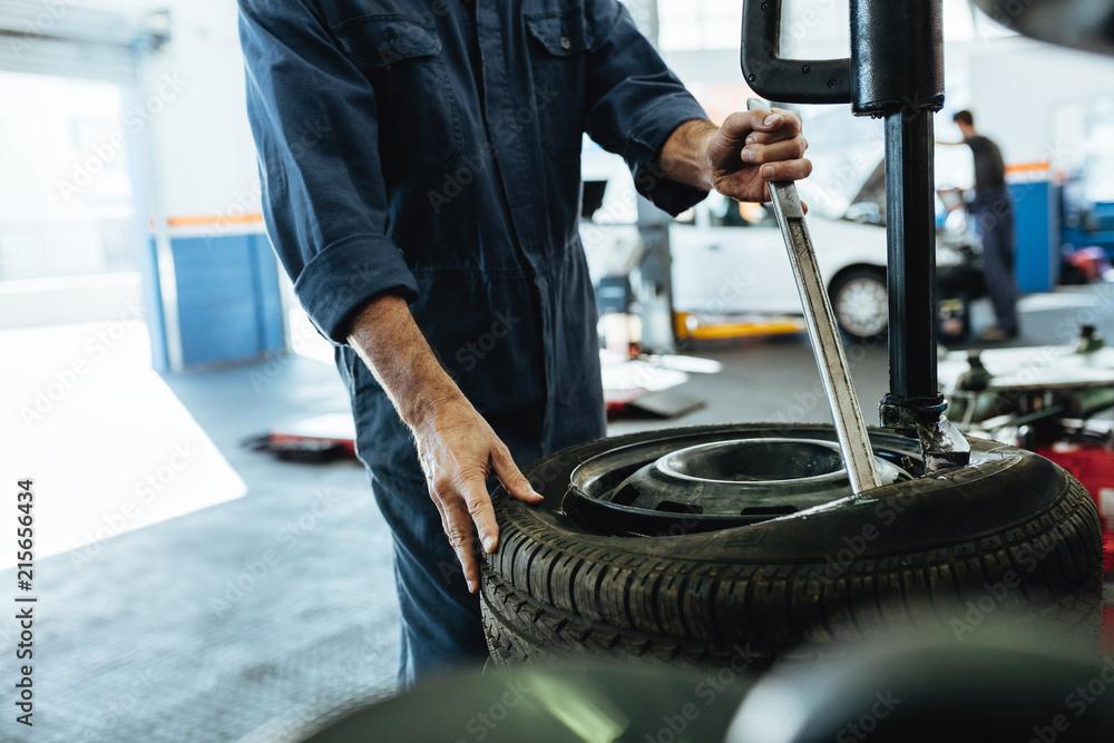 Mechanic working on tire changing machine