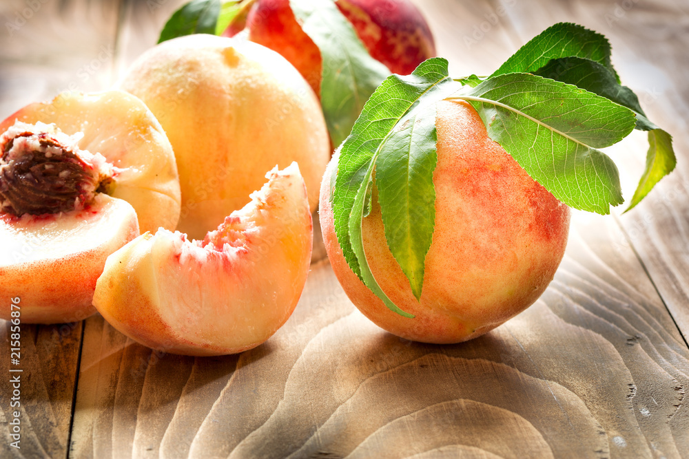 Juicy peach - healthy organic peach on table closeup