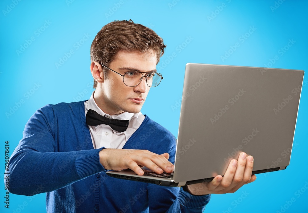 Male hands holding and using laptop