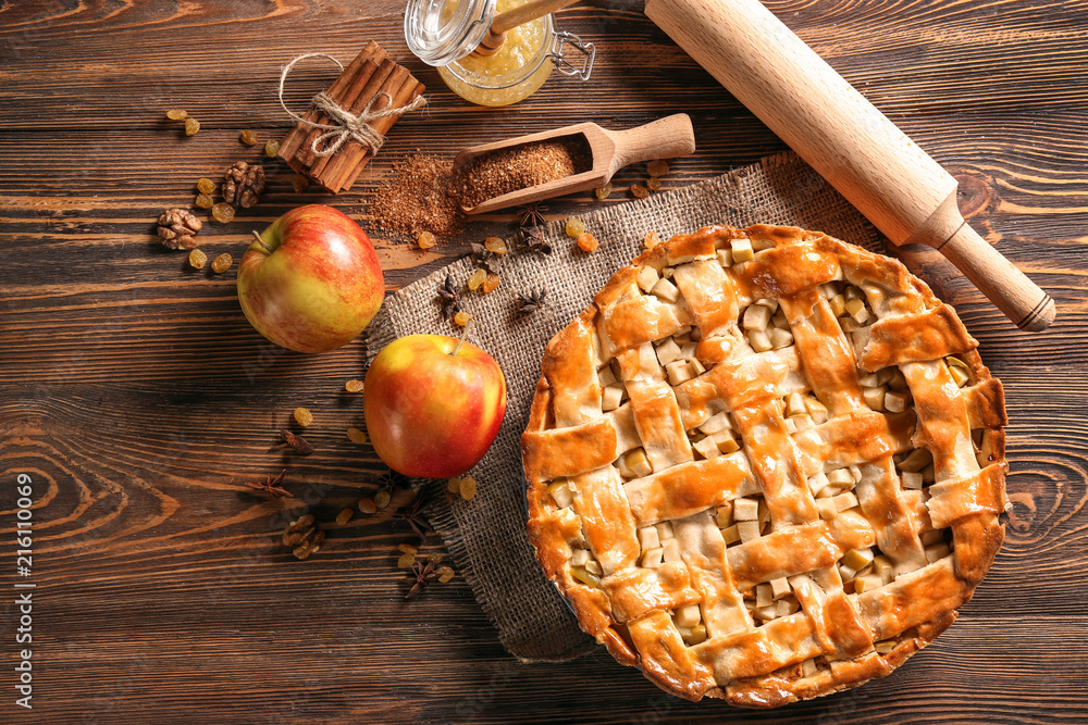 Composition with delicious apple pie on wooden table