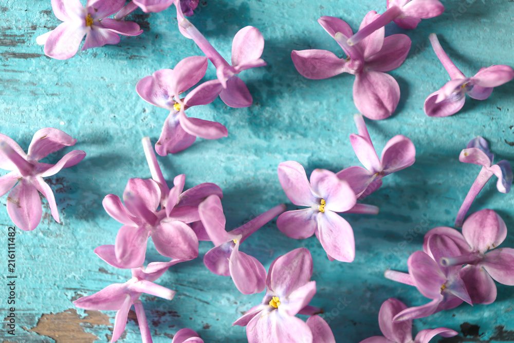 Beautiful lilac flowers on table, closeup