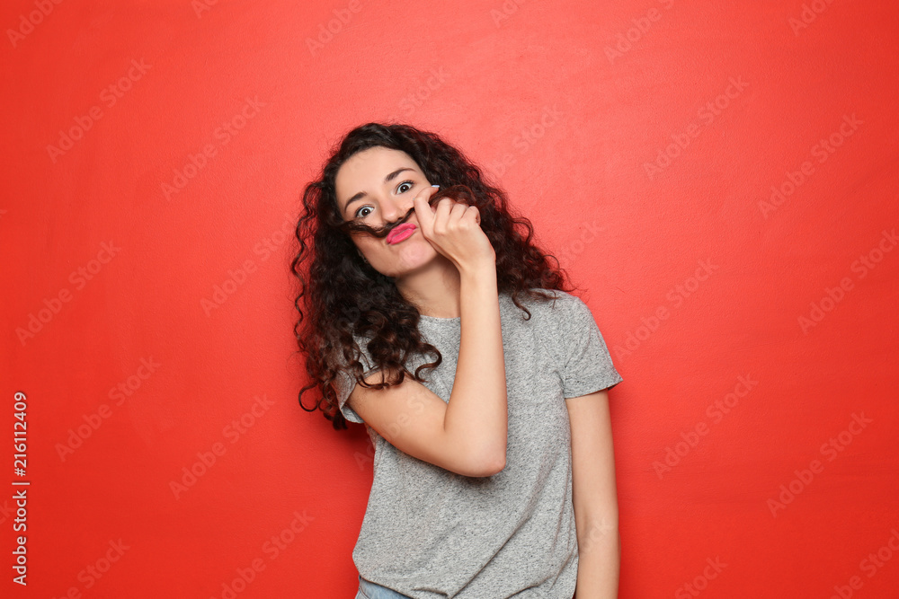 Portrait of funny emotional girl on color background