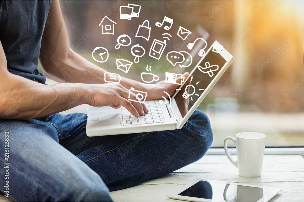 Male hands using laptop on floor