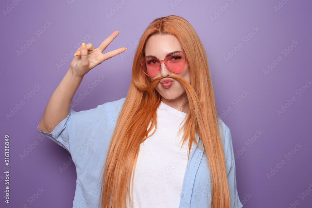 Funny young woman on color background