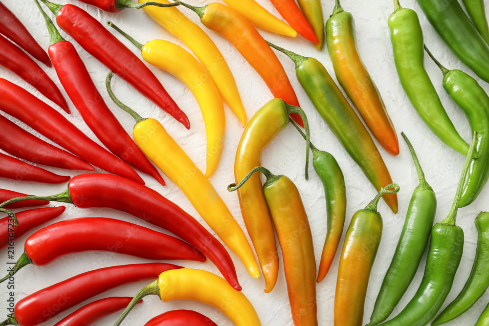 Fresh chili peppers on light background