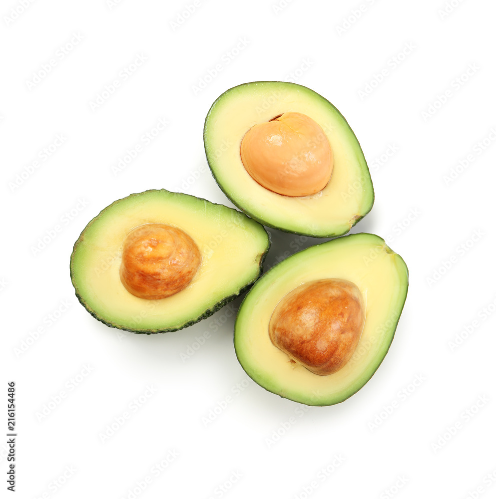 Halves of ripe avocados on white background