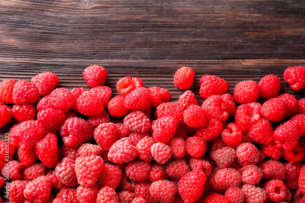 Ripe raspberry on wooden table