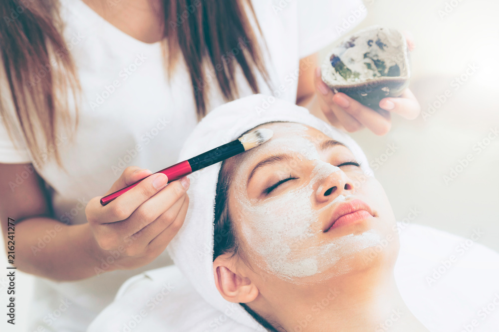 Beautiful woman having a facial treatment at spa.