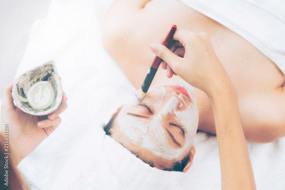 Beautiful woman having a facial treatment at spa.