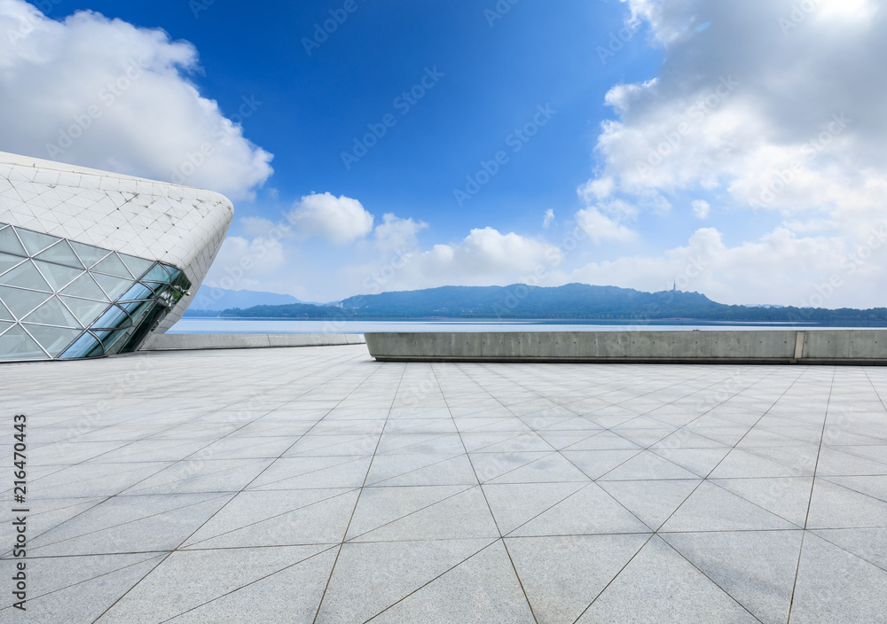 Empty square floor and mountain scenery under the blue sky