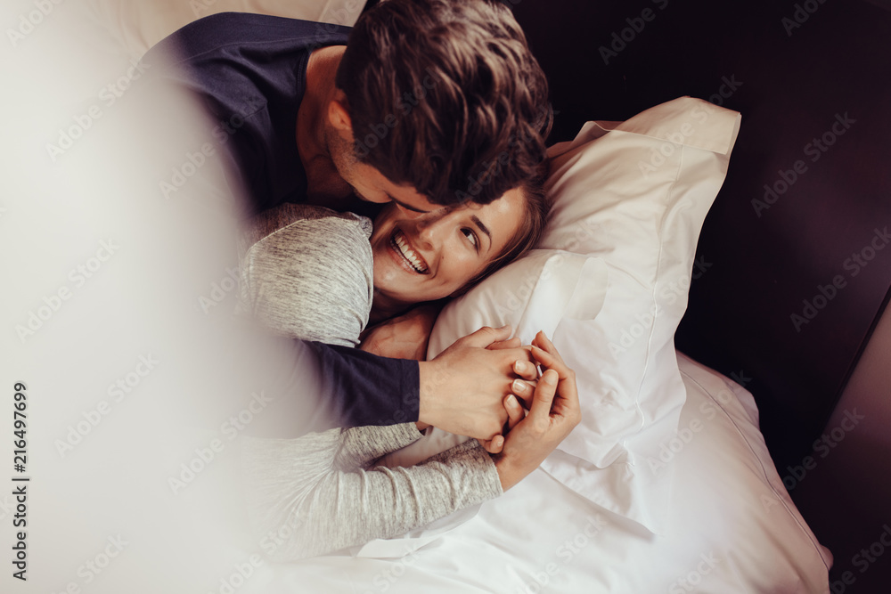 Romantic couple in love lying on bed