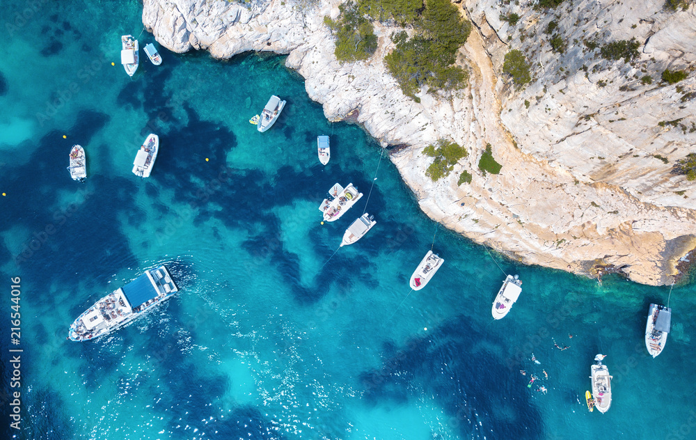 Yachts at the sea in France. Aerial view of luxury floating boat on transparent turquoise water at s