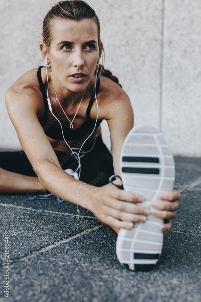 Fitness woman doing stretching exercises outdoors