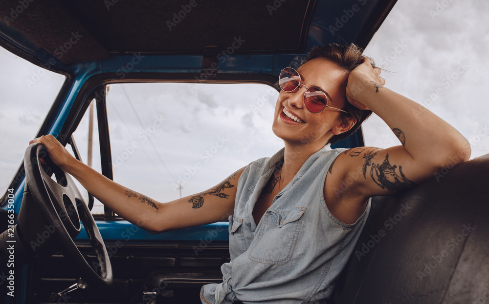 Woman with sunglasses driving a car.