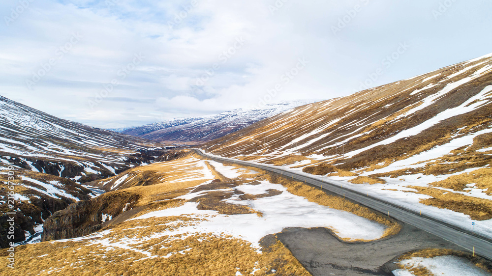 Beautiful road in Iceland countryside views and snowy mountain views. Aerial view