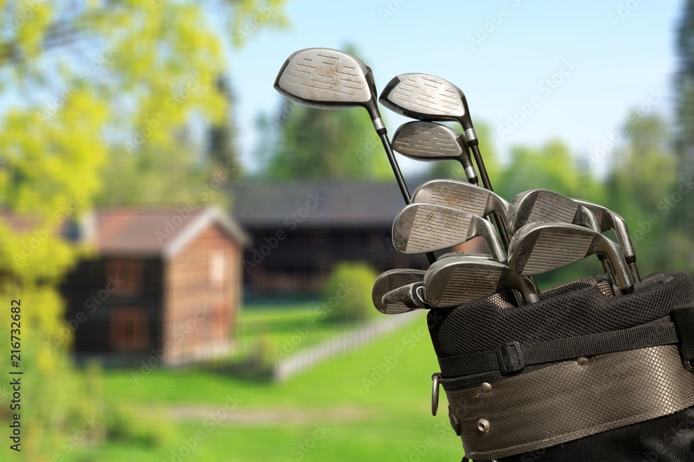 Different golf clubs on natural  background