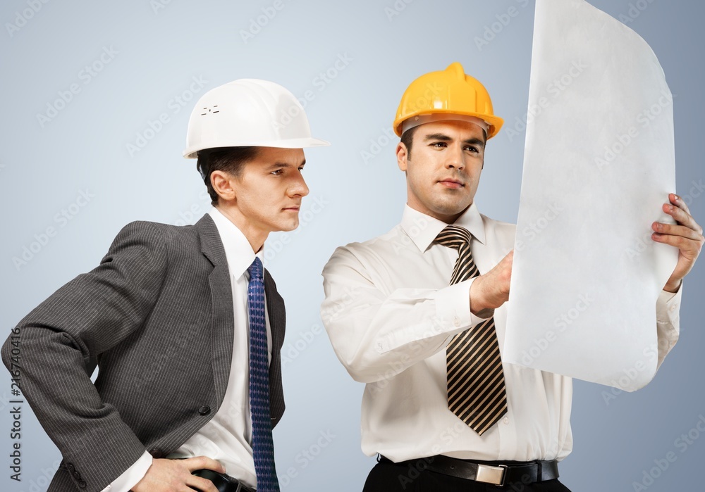 Two engineers men at construction site watching