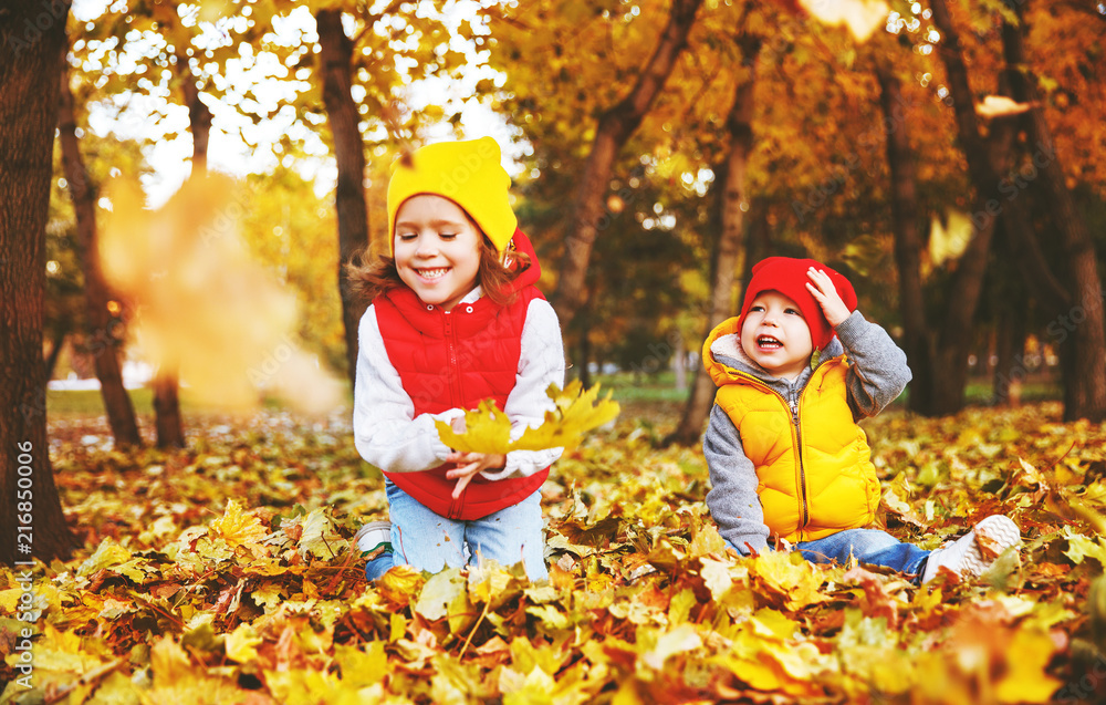 happy children boy and girl having fun   in autumn