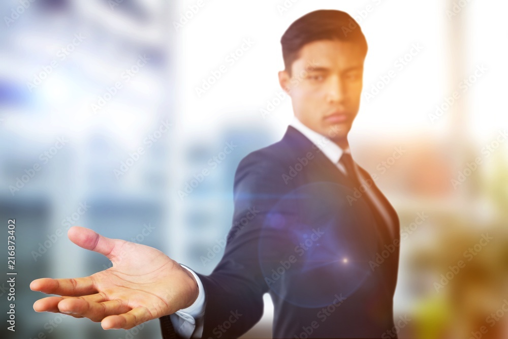 Composite image of confident businessman showing hand against