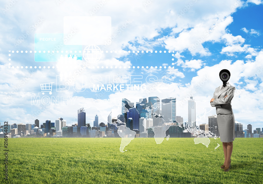 Camera headed woman standing on green grass against modern cityscape