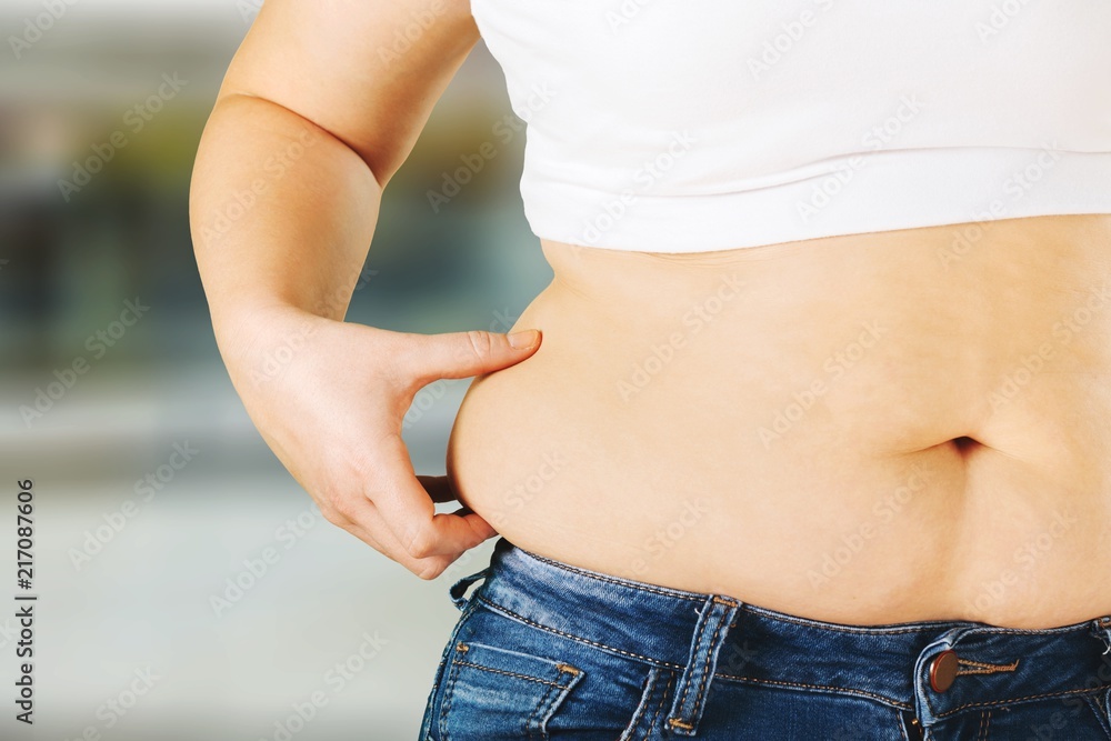 Woman with fat belly on  background.