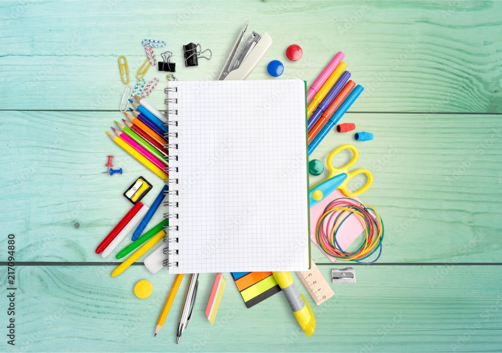 Colorful school supplies on wooden table background