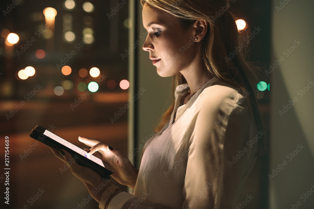 Beautiful female working late night in office