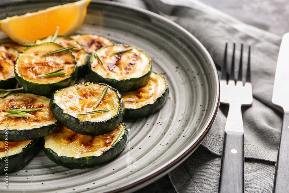 Tasty grilled zucchini on plate, closeup